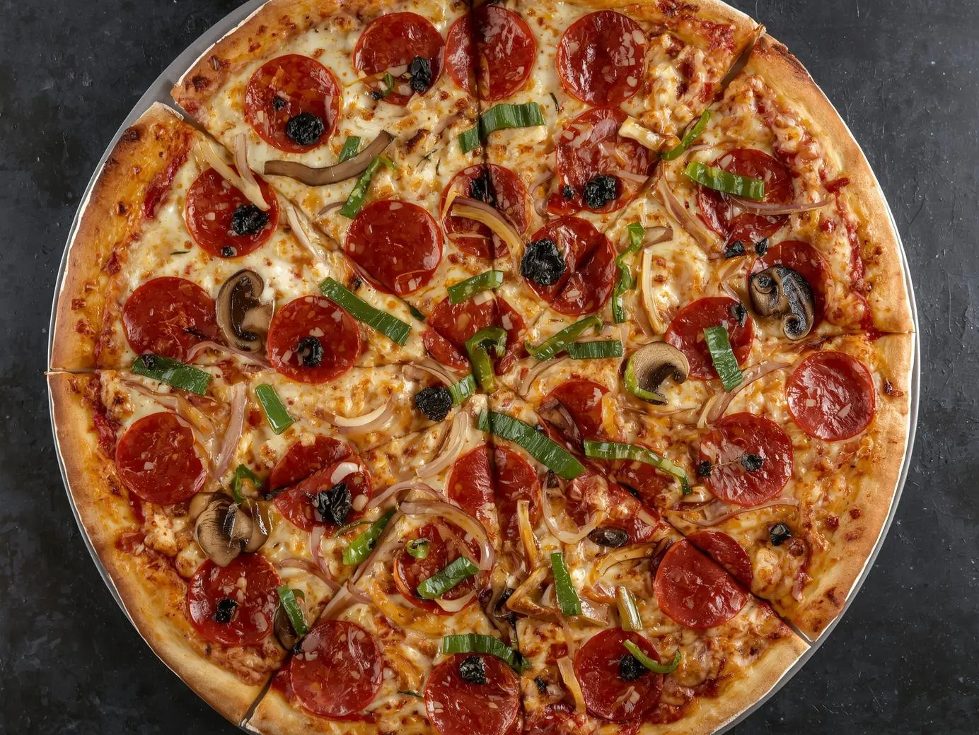 All-dressed deluxe pizza at Pizza Grande Calgary 17 Ave SE